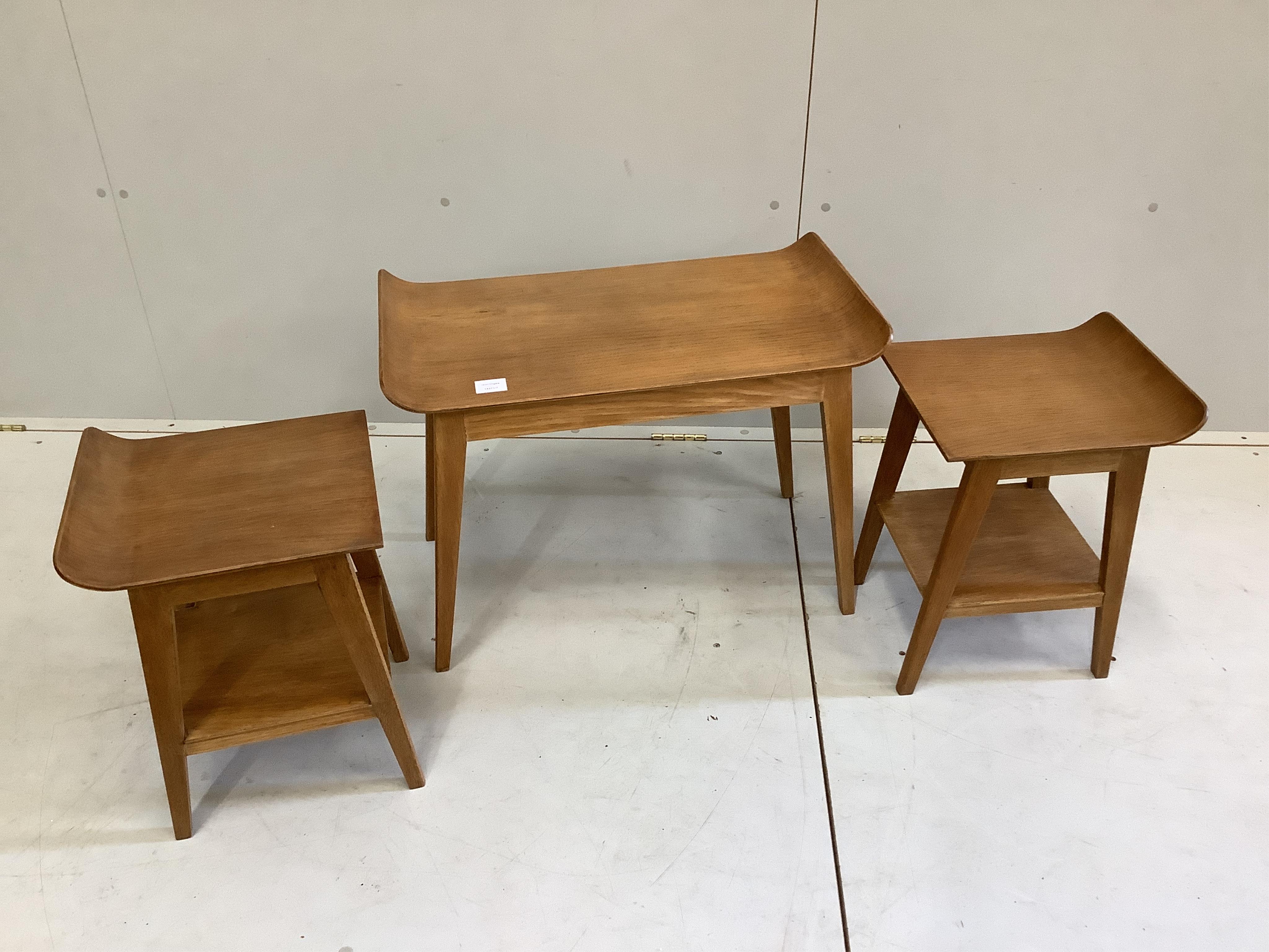 An oak nest of three mid century oak tea tables, width 67cm, depth 38cm, height 49cm